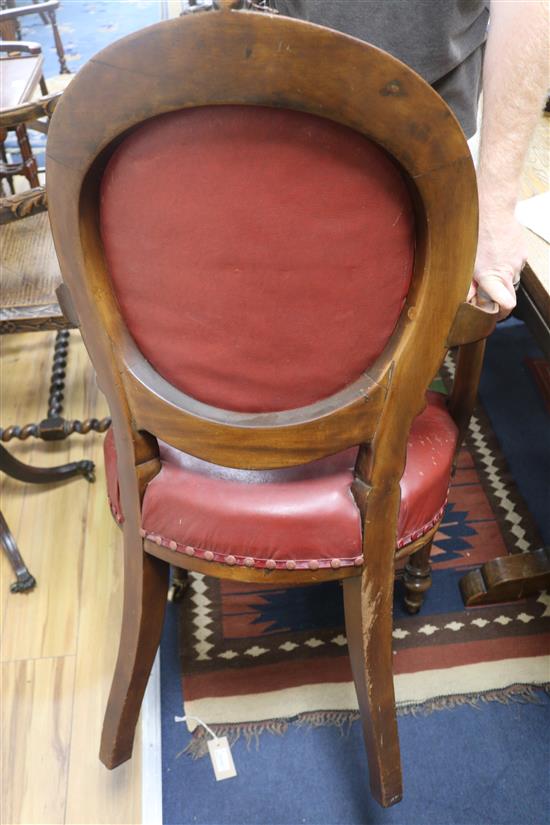 A Victorian red leather elbow chair